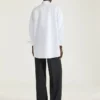 Asymmetrisk skjorte i poplin med pailletter Asymmetrisk skjorte i poplin med pailletter